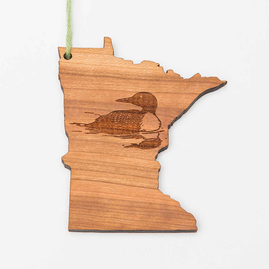Laser etched loon on a wood ornament shaped like Minnesota