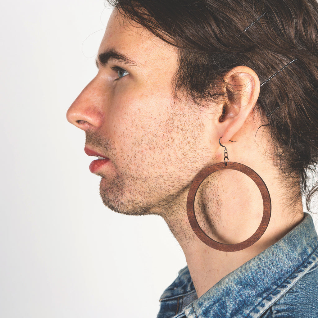 Model wearing grand sized laser cut wood earrings from Create Laser Arts